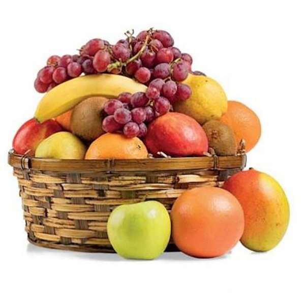 Basket of assorted fruit with grapes, bananas, apples, and citrus