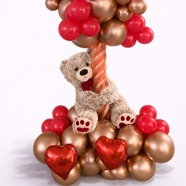 Teddy bear with red and gold heart balloons