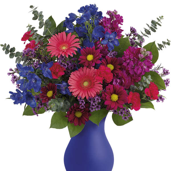 Colorful bouquet in a blue vase with pink, purple, and blue flowers