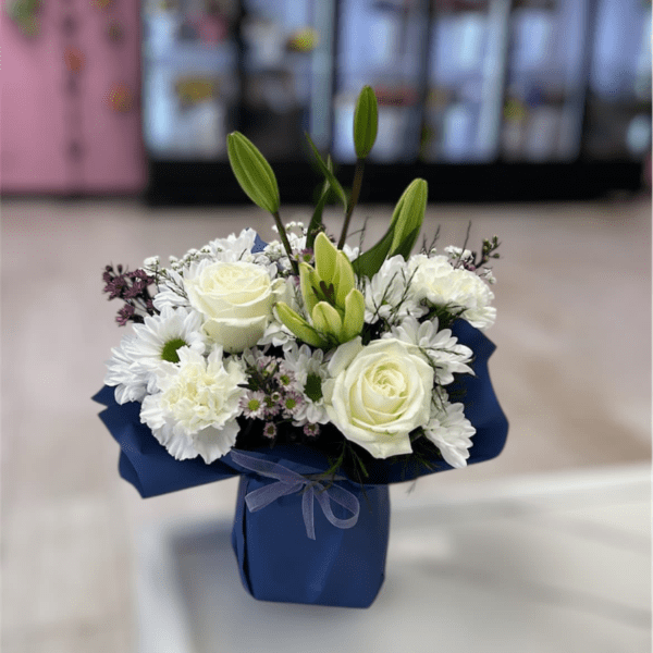 White rose and lily bouquet in a blue box