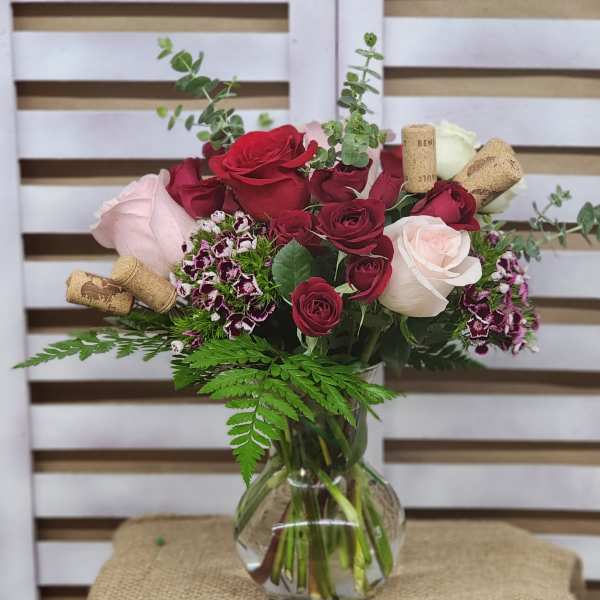 Bouquet of red and pink roses in a clear glass vase