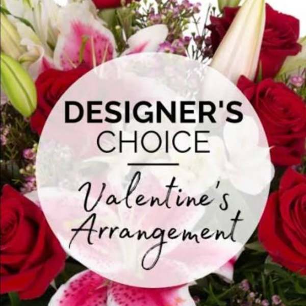 Bouquet of red roses and pink lilies with a Valentine’s label