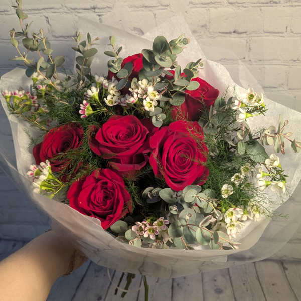 Bouquet of red roses with white filler flowers and eucalyptus