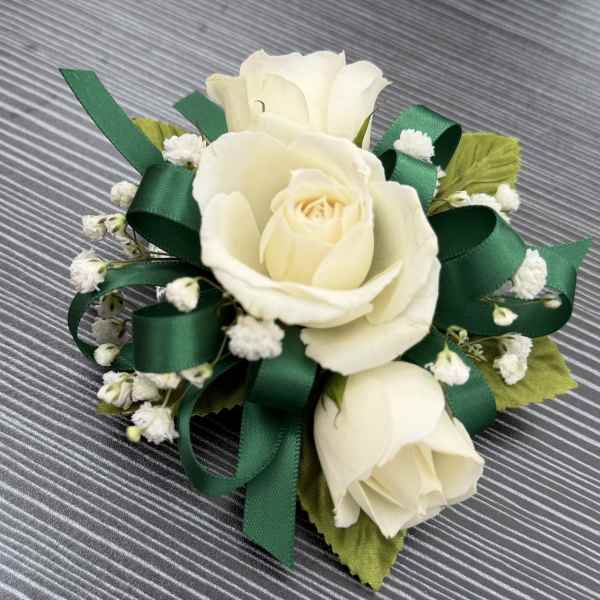 White rose corsage with green ribbon and baby's breath