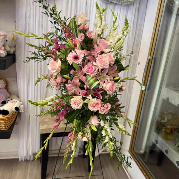 Tall pink and white floral arrangement on a stand