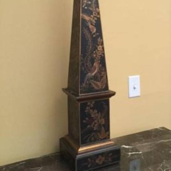 Tall decorative obelisk with floral pattern on a dark base