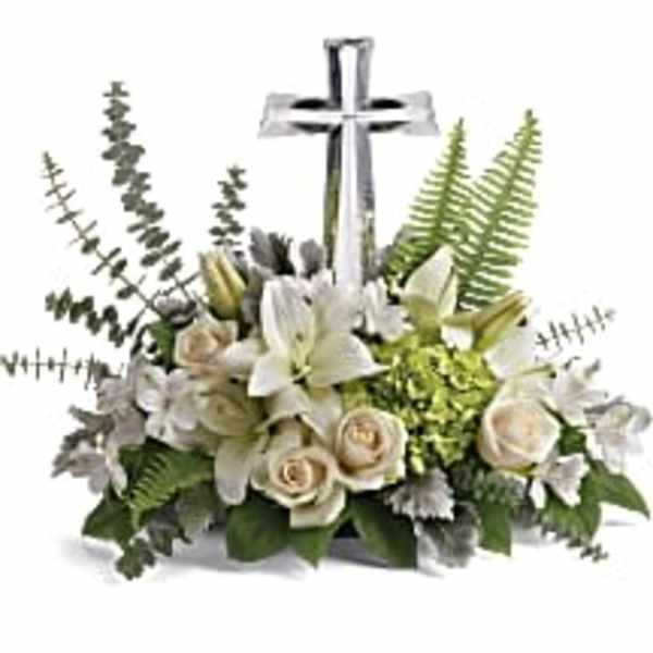 White floral arrangement with a silver cross centerpiece