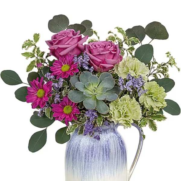 Pink roses and daisies in a blue-and-white pitcher vase