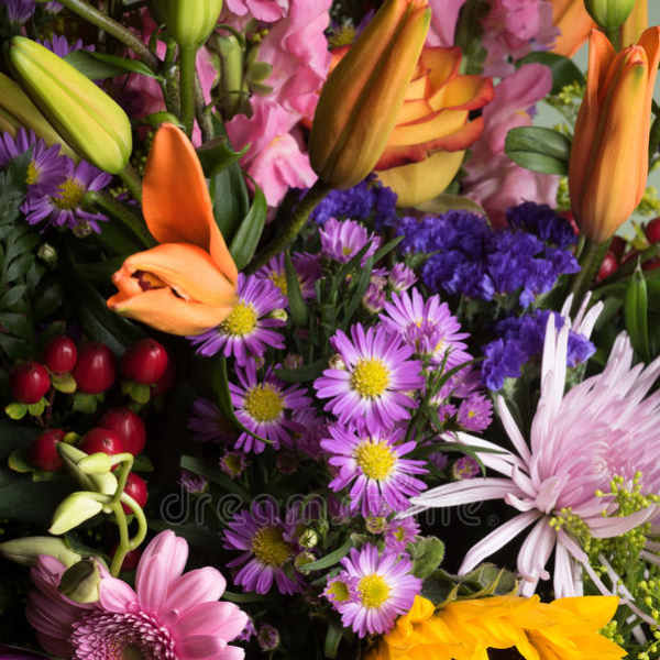 Colorful mixed bouquet with lilies, daisies, sunflowers, and hydrangeas