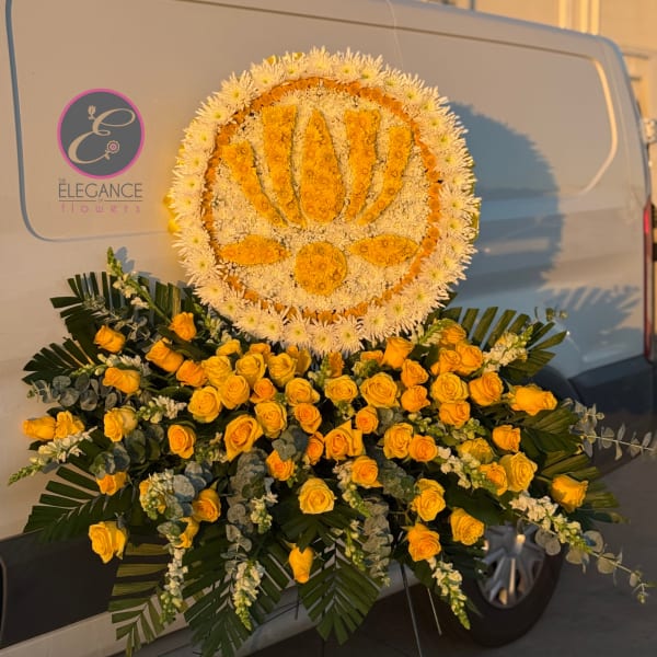 Large yellow and white floral funeral tribute on a stand