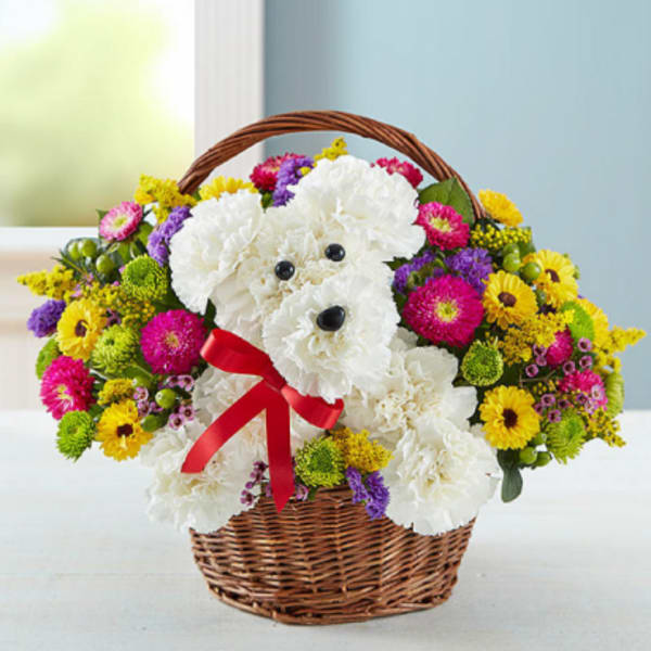 Basket of flowers arranged as a teddy bear with a red ribbon