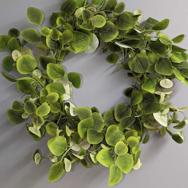 Green leafy wreath on a gray background