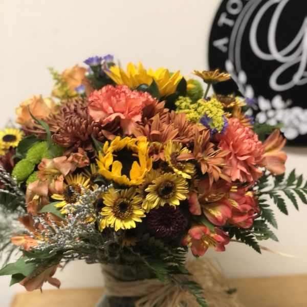 Mixed bouquet of sunflowers, chrysanthemums, and alstroemeria in a vase