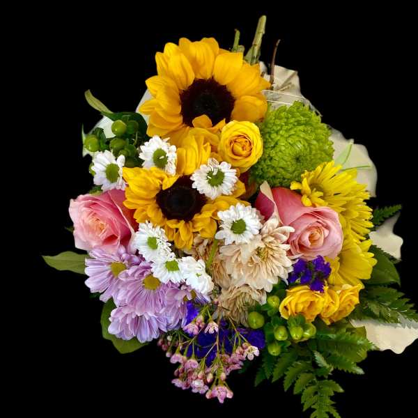 Mixed bouquet with sunflowers, pink roses, and daisies