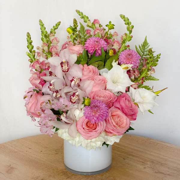 Pink and white floral arrangement in a white vase