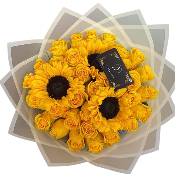 Yellow roses and sunflowers wrapped in layered translucent paper