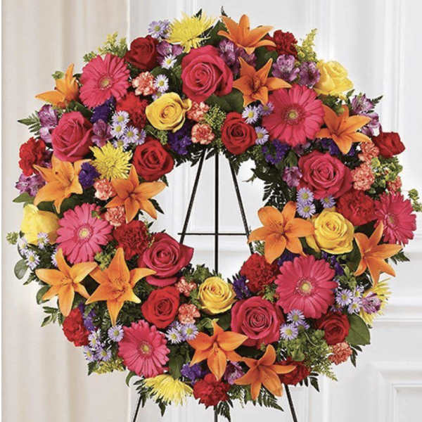 Colorful floral wreath on a black easel stand