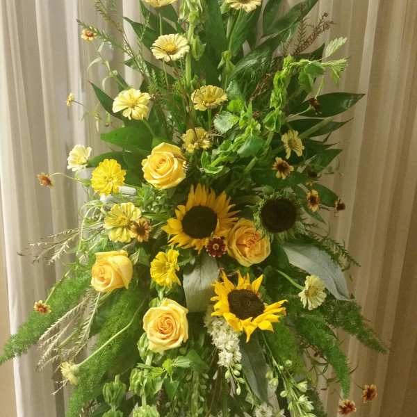 Tall floral spray with yellow roses and sunflowers