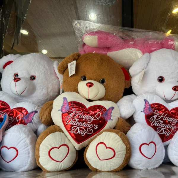 Plush teddy bears with heart decorations and Valentine’s Day text
