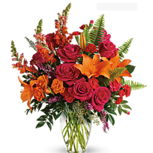 Bouquet of pink roses and orange lilies in a clear glass vase