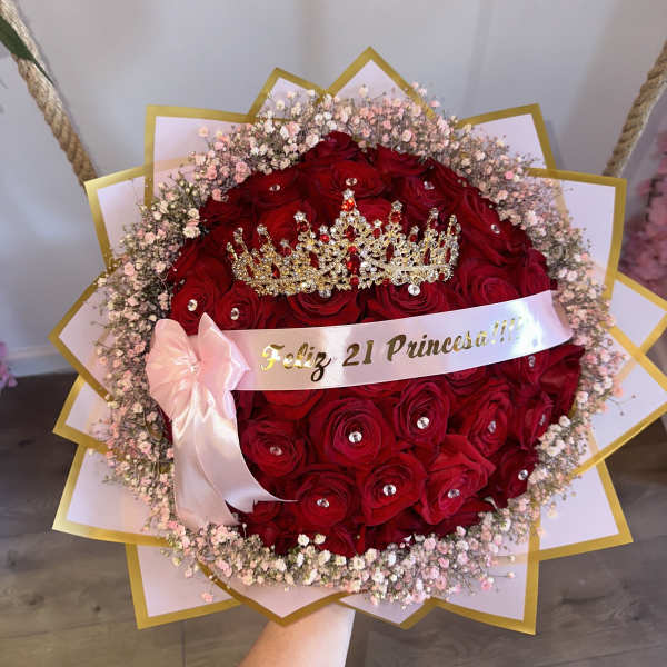 Red rose bouquet with a jeweled crown and pink ribbon