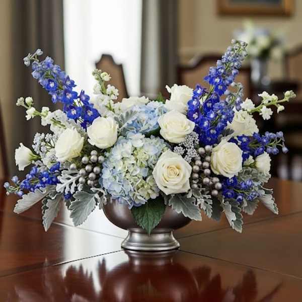 Blue and white floral centerpiece in a silver bowl vase