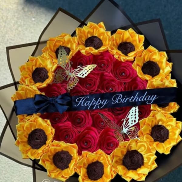 Round bouquet of red and yellow flowers with a Happy Birthday ribbon