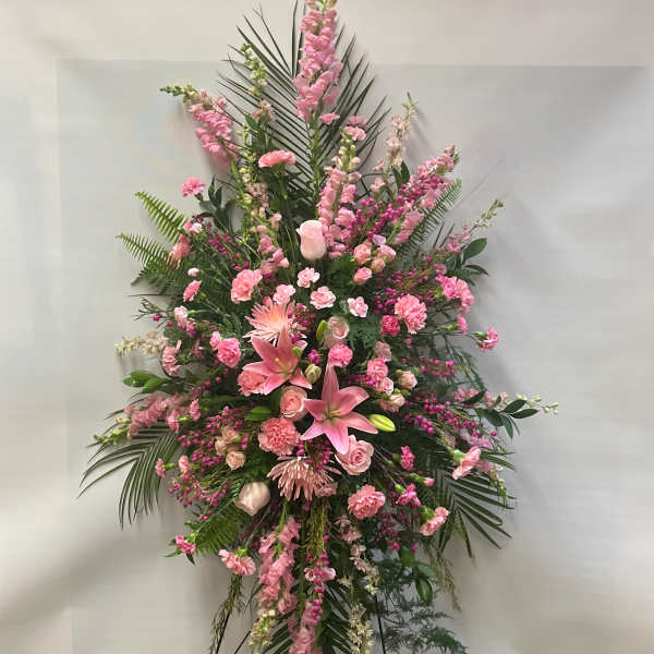 Large pink floral standing spray with lilies and carnations
