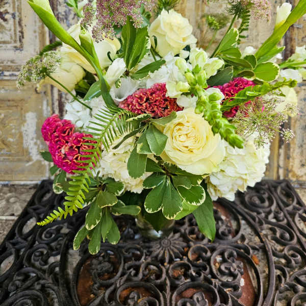 Bouquet of cream roses and white blooms with pink accents