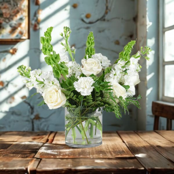 White roses and carnations in a clear glass vase