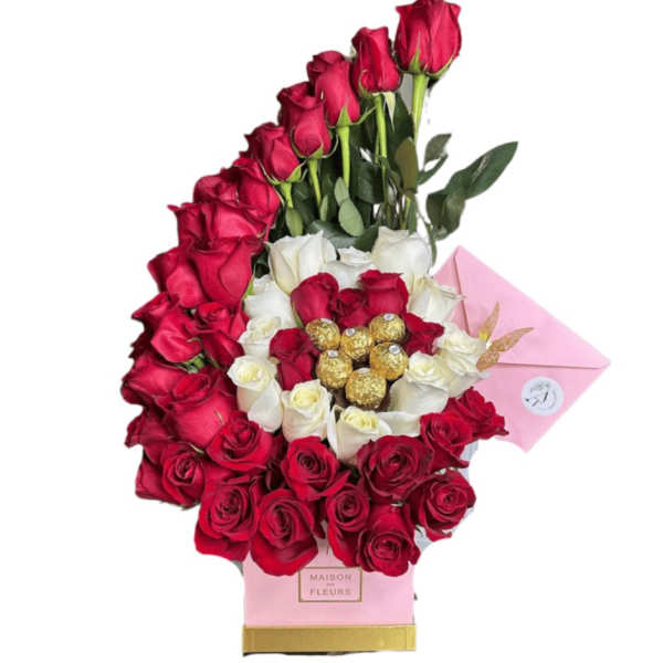 Red and white roses arranged with chocolates in a pink box