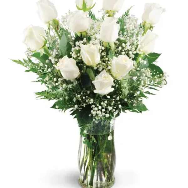 White roses in a clear glass vase with baby's breath