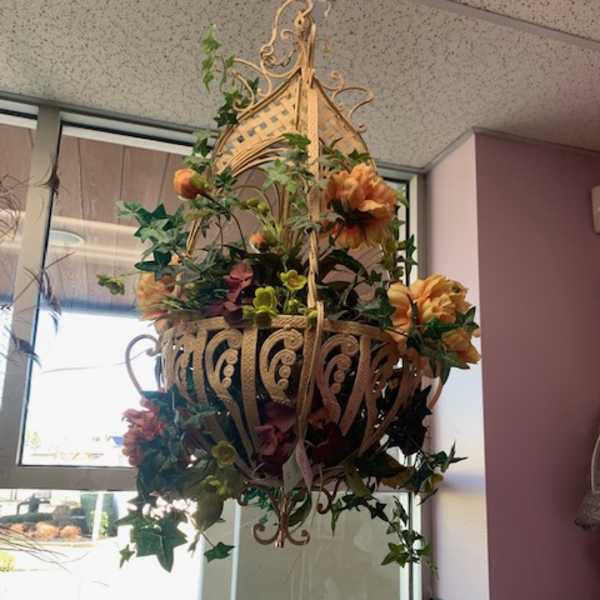 Hanging floral basket with orange blooms and ivy