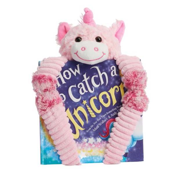 Pink unicorn plush holding a book-shaped gift