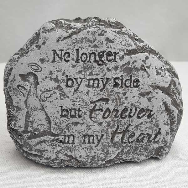 Decorative stone with engraved text and a small angel figure