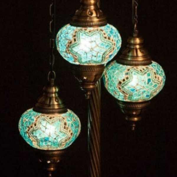 Three turquoise mosaic hanging lanterns on a bronze stand