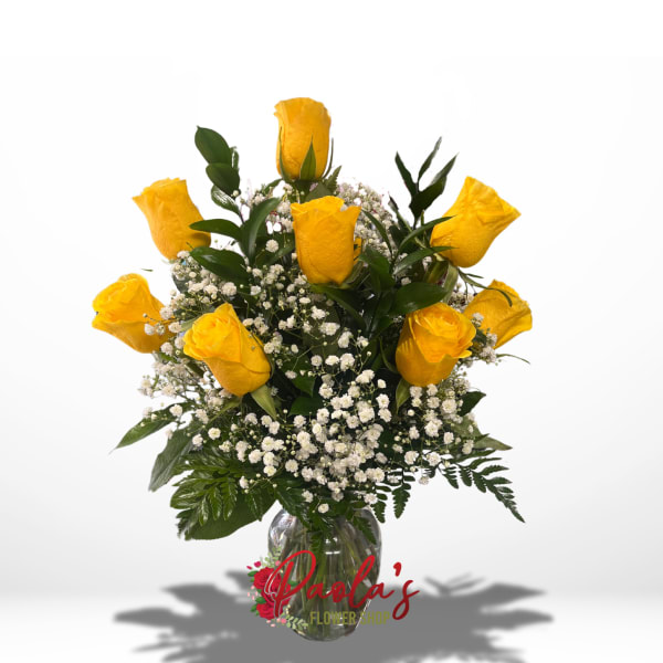 Yellow roses in a clear glass vase with white baby's breath