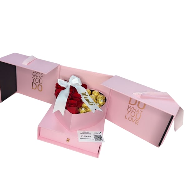 Pink gift box with red roses and gold chocolates tied with a white ribbon