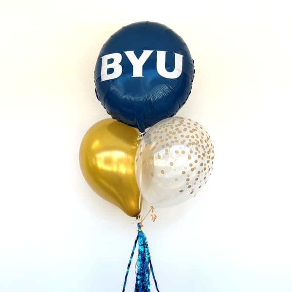 Blue, gold, and clear balloons with BYU text and tassels