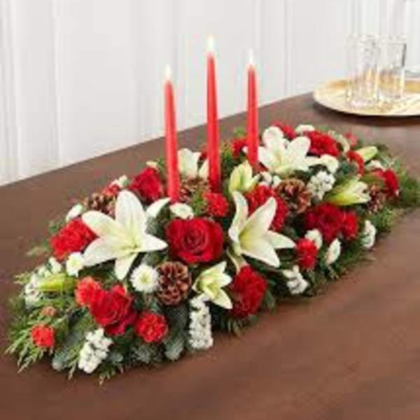 Red and white floral centerpiece with tall red candles