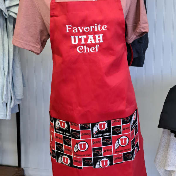 Red apron with "Favorite Utah Chef" text and University of Utah logos