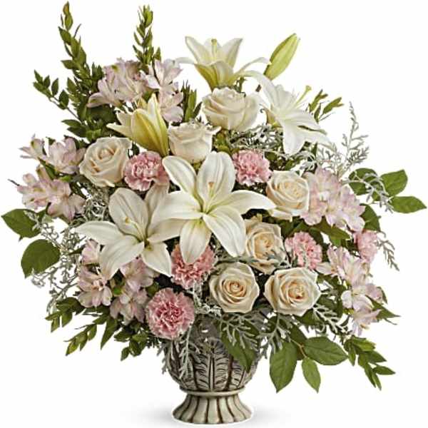 Bouquet of white lilies, cream roses, and pink carnations in a decorative vase
