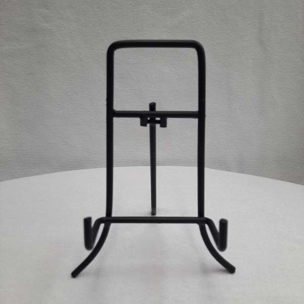 Black metal display stand on a white surface