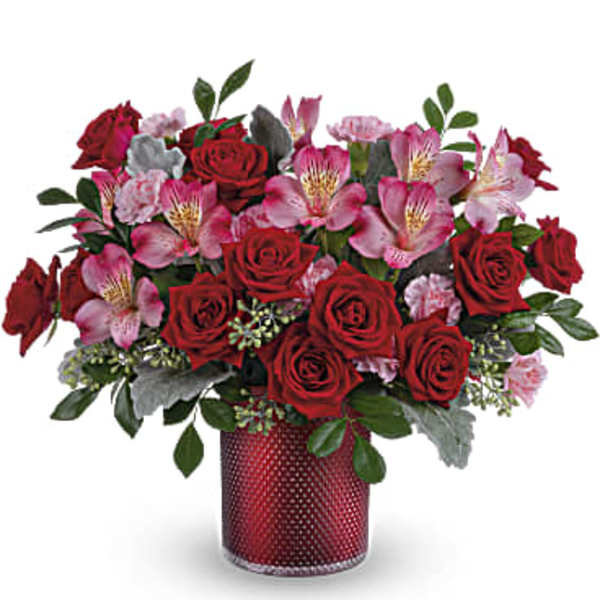 Red roses and pink alstroemeria in a red vase