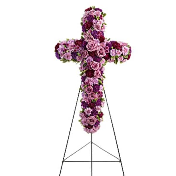 Purple and pink floral cross on a metal stand