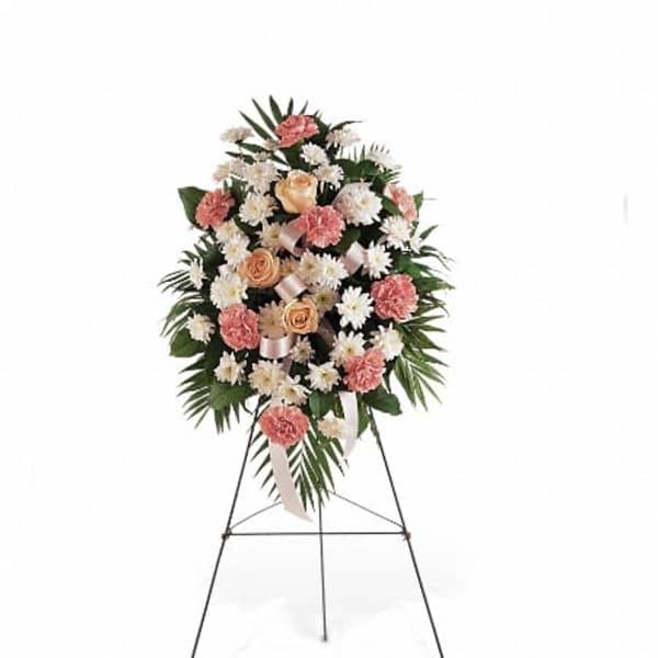 Standing floral spray with pink and white flowers on an easel