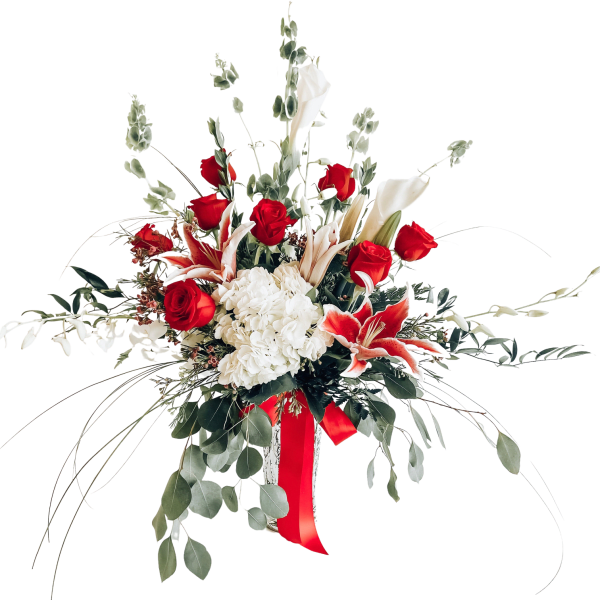 Red roses and white lilies in a tall vase with a red ribbon