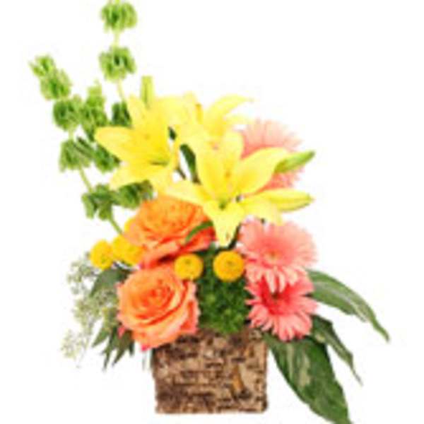 Mixed bouquet in a woven basket with yellow lilies and orange roses