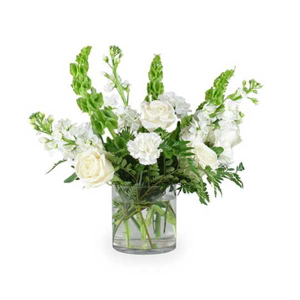 White roses and carnations in a clear glass vase