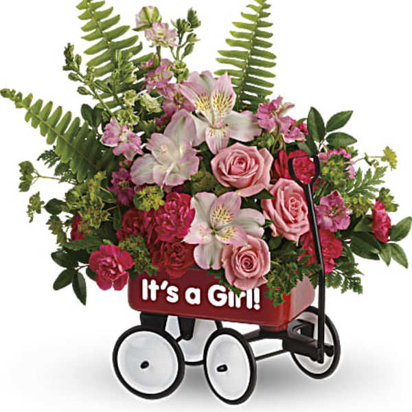 Pink floral arrangement in a red wagon with "It's a Girl!" text